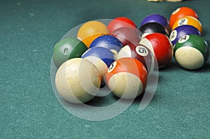 Old billiard balls composition on green pool table