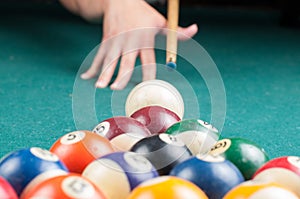 Old billiard balls and stick on a green table. billiard balls isolated on a green background