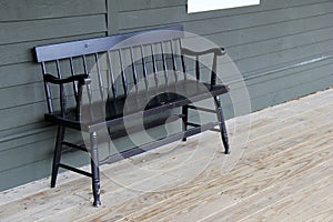 Old black bench on wood porch