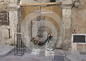 Old Black bicycle turned into a flower display in Matera, Italy