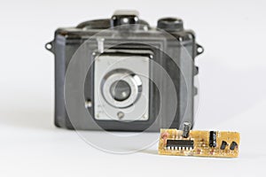 Old black camera and modern electronic component photo