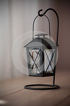Old black candle lamp on the table