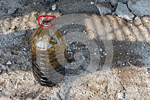 Old black car oil is poured into containers for further processing