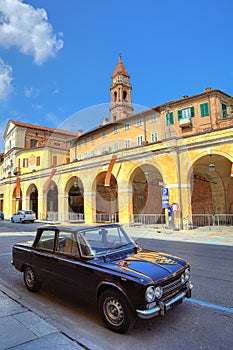 Old black car on the street in Bra, Italy.