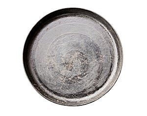 Old black cast iron Frying pan isolated on white background top view close-up.