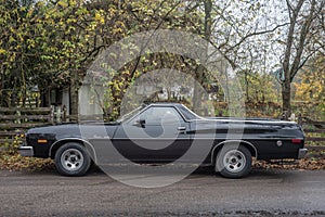 Old black classic Ford pick up car at a car show