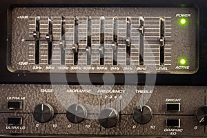 Old black controls of an audio equalizer from a guitar amplifier