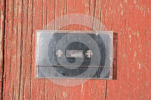 Old black film audio cassette on a wooden table