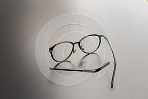 Old black glasses with broken legs.