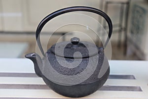 Old black iron tea pot