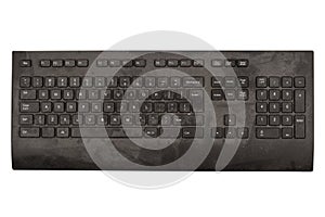 old black keyboard with keys covered in dust and dirt isolated on white background