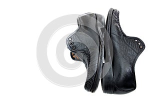 Old black leather shoes isolated on white