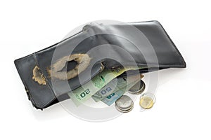 Old black leather wallet with money isolated.