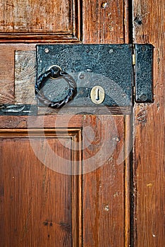 Old black lock with round handle on door