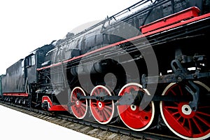 Old black locomotive on an isolated white background