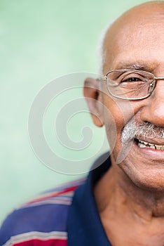 Old black man with glasses and mustache smiling