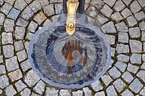 An old black metal (vintage) drinking fountain shellfish shape (shaped) with golden tap