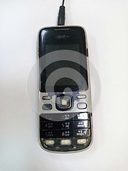 old black phone with some broken keys