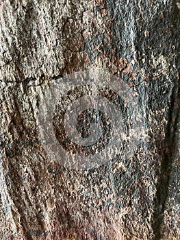 Old black and red granite wall texture background with cracks