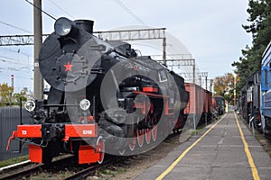 Old black and red steam train on rails