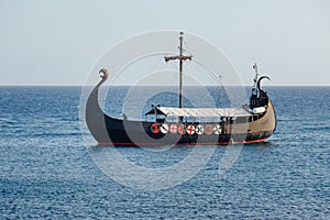 Old black ship in the open sea