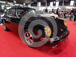 Old black sport 1967 Porsche 912 speedster coupe on the red carpet. Exhibit hall. Classic car show