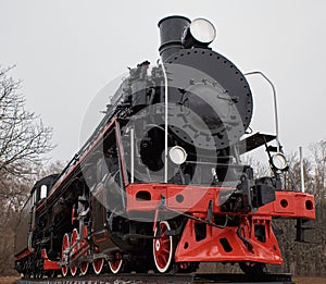 Old black steam locomotive with red decoration