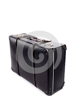 An old black vintage leather suitcase with straps and locks