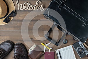 Old black vintage suitcase with welcome text