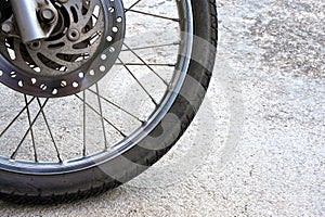 Old black wheel of motorcycle and disc brake