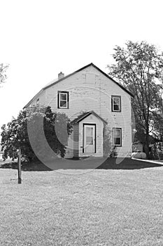 Old black and white farm house and yard