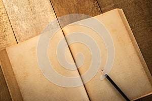 Old blank book open with pancil