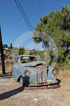 Old blue abandonned car samos greece road side car wreck