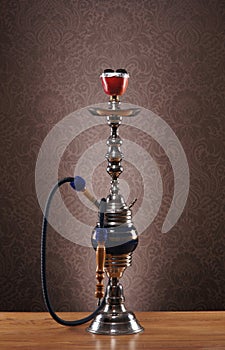 An old blue ceramic hookah on a blue background