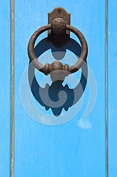 Old blue door with clapper