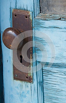 An old blue door and doorknob.