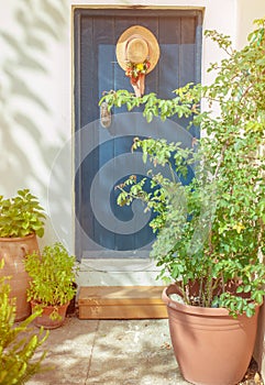 Old blue door with hat and flowers