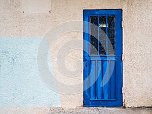 Old blue door. Metal door with carved figures