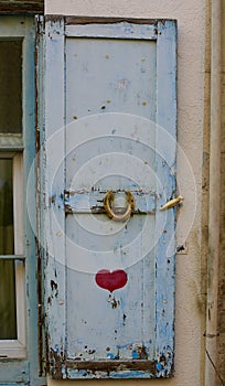 An old blue door with painted heart