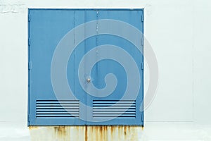 Old blue door with white concrete background.