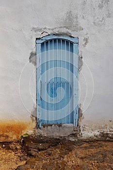 old blue door and worn white wall