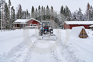 Old blue fordson dexta tractor plowing snow photo