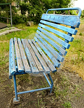 Old blue garden bench on the grass