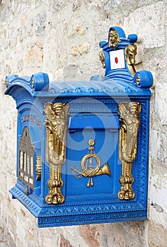 Old blue german mailbox with gold details