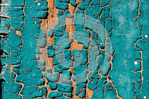 Old blue green cracked paint texture on a wooden background