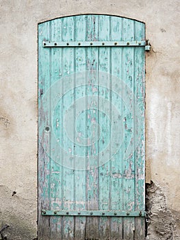 Old blue green door with peeling paint