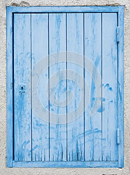 Old blue green door with peeling paint