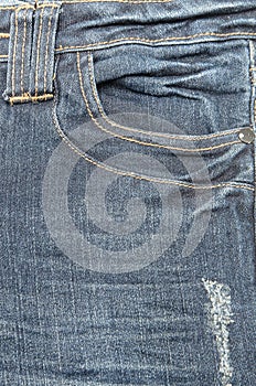 Old blue jeans pocket close-up