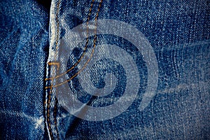 Old blue jeans seam detail cloth of denim for pattern and classic background close up