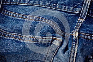 Old blue jeans seam detail cloth of denim for pattern and classic background close up